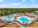 A stunning aerial view of a resort-style pool area with slides, cabanas, and lush landscaping at 4321 Hawkins Dr., Myrtle Beach, SC 29579