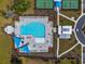 A bird's eye view of a sparkling community pool, tennis courts, and surrounding manicured grounds at 4321 Hawkins Dr., Myrtle Beach, SC 29579