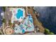 Aerial view of a waterpark-style community pool with playground, lounge areas, and a scenic pond at 4321 Hawkins Dr., Myrtle Beach, SC 29579