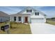 Charming single Gathering home with a welcoming front porch and an inviting orange front door at 448 Acosta Circle, Conway, SC 29527