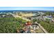 A picturesque aerial scene shows houses adjacent to a golf course and serene lake at 4494 Aberdeen Way, Myrtle Beach, SC 29579