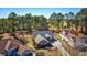 Aerial view of a neighborhood featuring well-manicured lawns and mature trees, golf course in the distance at 4494 Aberdeen Way, Myrtle Beach, SC 29579