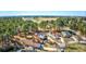 Aerial view of homes surrounded by mature trees and foliage, with golf course in the background at 4494 Aberdeen Way, Myrtle Beach, SC 29579