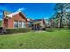 Brick home with a well-maintained lawn and established landscaping at 4494 Aberdeen Way, Myrtle Beach, SC 29579