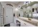 Bright bathroom with double sinks, a large mirror, and a glass-enclosed shower at 4494 Aberdeen Way, Myrtle Beach, SC 29579