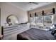 Bright bedroom with a large bed, dresser, and natural light from the windows at 4494 Aberdeen Way, Myrtle Beach, SC 29579