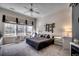 Well-lit bedroom featuring a comfortable bed, dresser, and large windows at 4494 Aberdeen Way, Myrtle Beach, SC 29579