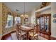 Formal dining room with classic wood furniture and elegant china cabinet at 4494 Aberdeen Way, Myrtle Beach, SC 29579