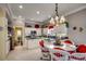 Modern kitchen with white cabinets, granite countertops, and a breakfast table at 4494 Aberdeen Way, Myrtle Beach, SC 29579