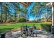 Outdoor patio seating area with a view of the lush green lawn and mature trees at 4494 Aberdeen Way, Myrtle Beach, SC 29579