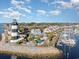 An aerial view of a lighthouse, community pool, and waterfront marina against a partly cloudy sky at 4535 Lightkeepers Dr. # 27B, Little River, SC 29566