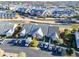 Aerial view showcasing condo buildings, green spaces, and parking areas near the marina at 4535 Lightkeepers Dr. # 27B, Little River, SC 29566