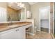 Well lit bathroom features granite countertops, large mirror, walk-in shower with tiled walls, and an attached closet at 4535 Lightkeepers Dr. # 27B, Little River, SC 29566