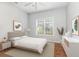 Serene bedroom featuring a neutral color palette, a ceiling fan, and a bright window at 4535 Lightkeepers Dr. # 27B, Little River, SC 29566