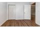 Bedroom with wood-look floors, closet, and an open door leading to another room at 4535 Lightkeepers Dr. # 27B, Little River, SC 29566