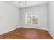 This bedroom offers wood-look floors, ceiling fan, and a large window with neighborhood views at 4535 Lightkeepers Dr. # 27B, Little River, SC 29566