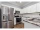 Well-equipped kitchen with stainless steel appliances and white cabinetry at 4535 Lightkeepers Dr. # 27B, Little River, SC 29566