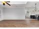 Inviting living room features wood-look floors, ceiling fan, modern light fixture, and mirrored wall at 4535 Lightkeepers Dr. # 27B, Little River, SC 29566