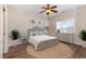 Cozy bedroom with a large window, ceiling fan, and stylish furnishings at 4535 Lightkeepers Dr. # 27B, Little River, SC 29566