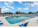 Outdoor community swimming pool surrounded by lounge chairs on a sunny day at 4535 Lightkeepers Dr. # 27B, Little River, SC 29566