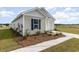 Well-maintained single-story home with fresh landscaping and a paved walkway leading to the entrance at 457 Acosta Circle, Conway, SC 29527