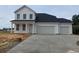 Newly constructed two-story home featuring a three-car garage and a concrete driveway at 467 Joseph St, Longs, SC 29568