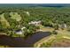 Aerial view of a golf course community, with lake, swimming pool, and lush vegetation at 48 Twelve Oaks Dr. # 3, Pawleys Island, SC 29585