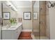 Well-lit bathroom with double vanity, artwork, and a walk-in glass shower at 48 Twelve Oaks Dr. # 3, Pawleys Island, SC 29585