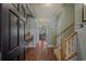 Inviting foyer with hardwood floors and staircase, creating a warm and welcoming entrance to the home at 48 Twelve Oaks Dr. # 3, Pawleys Island, SC 29585