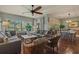 Inviting living room with comfortable seating, a ceiling fan, and large windows that provide ample natural light at 48 Twelve Oaks Dr. # 3, Pawleys Island, SC 29585