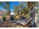 Outdoor patio with dining and lounge seating, complete with a grill, set amongst the trees and landscaping at 48 Twelve Oaks Dr. # 3, Pawleys Island, SC 29585