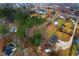 An aerial view showcases residential properties with a mix of wooded areas and clearings at 4908 Main St., Loris, SC 29569