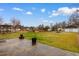 Large backyard with a mix of grass and clear areas, fencing, and metal garage at 4908 Main St., Loris, SC 29569
