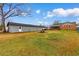 Wide open backyard with grass, storage unit, patio, and screen porch at 4908 Main St., Loris, SC 29569