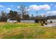 Expansive backyard with lush green grass, metal garage, and plenty of space at 4908 Main St., Loris, SC 29569