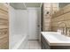 Full bathroom featuring wood paneling, tub/shower, and modern fixtures at 4908 Main St., Loris, SC 29569