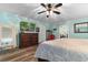 Comfortable bedroom with hardwood floors and a dresser with a mounted TV at 4908 Main St., Loris, SC 29569
