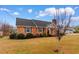 Charming brick home featuring a well-maintained lawn, mature shrubbery, and classic architectural details at 4908 Main St., Loris, SC 29569