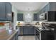 Well-lit kitchen featuring gray cabinetry, stainless steel appliances, and a modern design at 4908 Main St., Loris, SC 29569