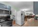 Open kitchen with gray cabinets, and appliances, seamlessly connecting to the dining and living areas at 4908 Main St., Loris, SC 29569