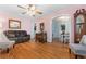 Bright living room with hardwood floors and an archway that provides an open view to the dining area at 4908 Main St., Loris, SC 29569