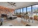 Charming sun room with brick walls, comfortable seating, and natural light at 4908 Main St., Loris, SC 29569