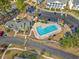 Aerial view showcasing community pool, parking, clubhouse, and manicured surroundings at 4929 Pond Shoals Ct. # 201, Myrtle Beach, SC 29579