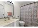 Well-lit bathroom features a vanity with sink and a decorative shower curtain at 4929 Pond Shoals Ct. # 201, Myrtle Beach, SC 29579