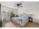 Cozy bedroom with a ceiling fan, large window, and sleek iron bed frame at 4929 Pond Shoals Ct. # 201, Myrtle Beach, SC 29579