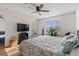 Bedroom featuring a ceiling fan, television, and door to the outside area at 4929 Pond Shoals Ct. # 201, Myrtle Beach, SC 29579