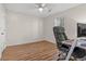 Cozy bedroom features a ceiling fan, wood-look flooring, and a comfortable office setup at 4929 Pond Shoals Ct. # 201, Myrtle Beach, SC 29579