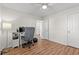 Functional bedroom with wood-look flooring, ceiling fan, and a practical computer setup at 4929 Pond Shoals Ct. # 201, Myrtle Beach, SC 29579