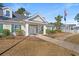 Charming clubhouse featuring pristine landscaping, and an inviting entrance with a bench and American flag at 4929 Pond Shoals Ct. # 201, Myrtle Beach, SC 29579