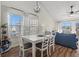 Bright dining area features a white table with seating for six and modern light fixture at 4929 Pond Shoals Ct. # 201, Myrtle Beach, SC 29579